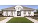 Attractive community clubhouse with manicured lawn, promoting a vibrant neighborhood atmosphere at 3776 Maxwell Park Dr, Sun City Center, FL 33573