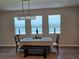 Bright dining area with modern chandelier, neutral walls, and bench seating at 3776 Maxwell Park Dr, Sun City Center, FL 33573