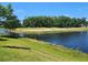 Scenic golf course view with a water hazard and sand trap visible from the property at 3776 Maxwell Park Dr, Sun City Center, FL 33573