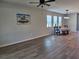 Bright and airy living space featuring hardwood floors and large windows, creating a warm and inviting atmosphere at 3776 Maxwell Park Dr, Sun City Center, FL 33573
