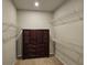 Walk-in closet with shelving and a large dresser at 3776 Maxwell Park Dr, Sun City Center, FL 33573