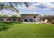 Beautiful backyard featuring a well-manicured lawn, a fire pit, and a covered patio perfect for outdoor relaxation at 3951 72Nd N St, St Petersburg, FL 33709