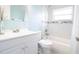 Well-lit bathroom featuring a bathtub with shower, tiled walls, modern fixtures, and a stylish vanity at 3951 72Nd N St, St Petersburg, FL 33709