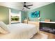 Bright bedroom with a ceiling fan, large window and modern furnishings at 3951 72Nd N St, St Petersburg, FL 33709