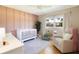 Charming Bedroom with crib, accent wall, and natural light from the window at 3951 72Nd N St, St Petersburg, FL 33709