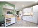 Open-concept kitchen featuring stainless steel appliances, white cabinets and modern breakfast bar at 3951 72Nd N St, St Petersburg, FL 33709