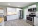 Well-lit kitchen with sleek stainless-steel appliances, crisp white cabinets, and modern tile flooring at 3951 72Nd N St, St Petersburg, FL 33709