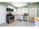 Bright kitchen featuring stainless steel appliances, white cabinets and modern backsplash at 3951 72Nd N St, St Petersburg, FL 33709
