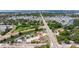 Expansive aerial view of a property near a waterway, showcasing community with verdant trees and a long connecting road at 4555 Hannah Ln, St Petersburg, FL 33709