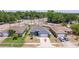 Aerial view of a charming blue home with a well-manicured lawn and a spacious driveway at 4555 Hannah Ln, St Petersburg, FL 33709