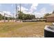 Large, grassy backyard with street and construction views; HVAC visible in corner at 4555 Hannah Ln, St Petersburg, FL 33709