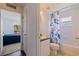 Bright bathroom featuring a shower-tub combo with stylish curtain and a single sink vanity at 4555 Hannah Ln, St Petersburg, FL 33709