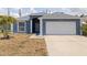 Charming blue home with a well-manicured lawn and a two-car garage at 4555 Hannah Ln, St Petersburg, FL 33709