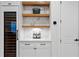 Stylish bar area featuring floating shelves, custom cabinetry, and a built-in wine fridge at 4612 W Lowell Ave, Tampa, FL 33629