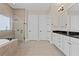 Luxurious bathroom featuring a soaking tub, glass shower, and double vanity sinks at 4612 W Lowell Ave, Tampa, FL 33629