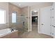 Bathroom with a glass shower, separate tub, and walk-in closet at 4612 W Lowell Ave, Tampa, FL 33629