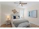Charming bedroom boasts a ceiling fan, plantation shutters, and a decorative woven-texture wall hanging at 4612 W Lowell Ave, Tampa, FL 33629