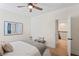 This bedroom features a ceiling fan, painting, and a doorway leading to a stairway at 4612 W Lowell Ave, Tampa, FL 33629