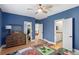 Bedroom with blue walls, laminate floors, and a convenient ensuite bathroom at 4612 W Lowell Ave, Tampa, FL 33629