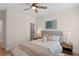 This stylish bedroom features a ceiling fan, matching bedside tables, and a decorative bench at 4612 W Lowell Ave, Tampa, FL 33629