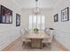 Bright dining room featuring wainscoting, shuttered windows, and a contemporary chandelier at 4612 W Lowell Ave, Tampa, FL 33629