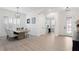 Elegant dining room featuring neutral walls, wood floors, and a modern light fixture at 4612 W Lowell Ave, Tampa, FL 33629