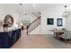 Open-concept dining room with wood floors, contemporary light fixture, and view of the staircase at 4612 W Lowell Ave, Tampa, FL 33629