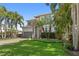 Charming two-story home with lush tropical landscaping and a brick driveway at 4612 W Lowell Ave, Tampa, FL 33629