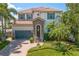 Charming two-story home featuring a tile roof, stone accents, and beautifully landscaped front yard at 4612 W Lowell Ave, Tampa, FL 33629