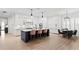 Bright kitchen with white cabinets, a blue island with seating, and modern pendant lighting at 4612 W Lowell Ave, Tampa, FL 33629
