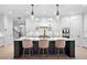 Bright kitchen with white cabinets, a dark island, and stylish pendant lighting at 4612 W Lowell Ave, Tampa, FL 33629