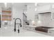 Modern kitchen with white quartz countertops, marble backsplash, and stainless steel appliances at 4612 W Lowell Ave, Tampa, FL 33629