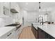 Elegant kitchen with a central island, white cabinetry, stainless appliances, and designer finishes at 4612 W Lowell Ave, Tampa, FL 33629