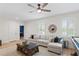 Bright living room featuring a comfortable sectional sofa and decorative mirror at 4612 W Lowell Ave, Tampa, FL 33629