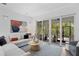 Bright living room with large sliding doors to the outdoor screened living area at 4612 W Lowell Ave, Tampa, FL 33629