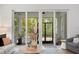 Cozy living room features a screened-in patio view with natural light flooding in at 4612 W Lowell Ave, Tampa, FL 33629