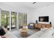 Cozy living room with sliding doors, a wood-style entertainment center, and comfortable seating at 4612 W Lowell Ave, Tampa, FL 33629