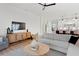 Open-concept living room leading to the kitchen with a neutral color palette and modern decor at 4612 W Lowell Ave, Tampa, FL 33629