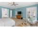 Bright primary bedroom features a balcony, a TV, and an ensuite bathroom for ultimate relaxation at 4612 W Lowell Ave, Tampa, FL 33629
