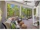 Relaxing screened lanai features brick flooring, comfortable seating, and views of lush backyard at 4612 W Lowell Ave, Tampa, FL 33629