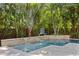 Stunning pool area is surrounded by lush landscaping and features a soothing waterfall feature at 4612 W Lowell Ave, Tampa, FL 33629