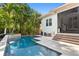 Backyard pool and patio with mature landscaping around the perimeter of the property at 4612 W Lowell Ave, Tampa, FL 33629