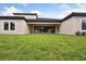 Expansive green backyard featuring large sliding glass doors leading into the home's interior at 4630 Cedar Fog Ct Dr, Valrico, FL 33596