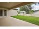 A covered patio opens up to a spacious backyard with lush green grass and a white fence at 4630 Cedar Fog Ct Dr, Valrico, FL 33596