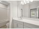 Well-lit bathroom featuring large mirror, vanity, and shower/tub combo at 4630 Cedar Fog Ct Dr, Valrico, FL 33596