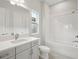 Clean bathroom with a shower-tub combo, window, and gray vanity at 4630 Cedar Fog Ct Dr, Valrico, FL 33596
