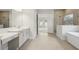 Bright bathroom featuring a walk-in shower, tub, and dual vanities at 4630 Cedar Fog Ct Dr, Valrico, FL 33596
