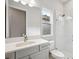 Bathroom featuring shower, tile flooring, vanity with quartz counters, and a window at 4630 Cedar Fog Ct Dr, Valrico, FL 33596