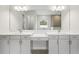 Bathroom with dual vanities, white countertops, and a large mirror at 4630 Cedar Fog Ct Dr, Valrico, FL 33596