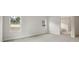 Bedroom with neutral carpet, two windows, and access to an en-suite bathroom at 4630 Cedar Fog Ct Dr, Valrico, FL 33596